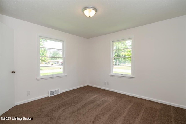 6100 Jessamine Ln, Louisville, KY 40258 - empty room featuring dark colored carpet and baseboards