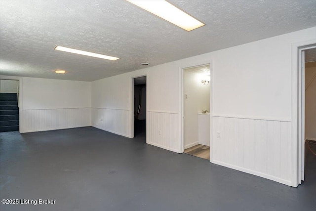 6100 Jessamine Ln, Louisville, KY 40258 - below grade area featuring a textured ceiling and wainscoting