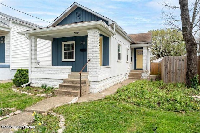 1205 Fischer Ave, Louisville, KY 40204 - shotgun-style home with covered porch and board and batten siding