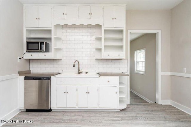 1205 Fischer Ave, Louisville, KY 40204 - kitchen with open shelves, appliances with stainless steel finishes, a sink, light wood-style floors, and white cabinetry