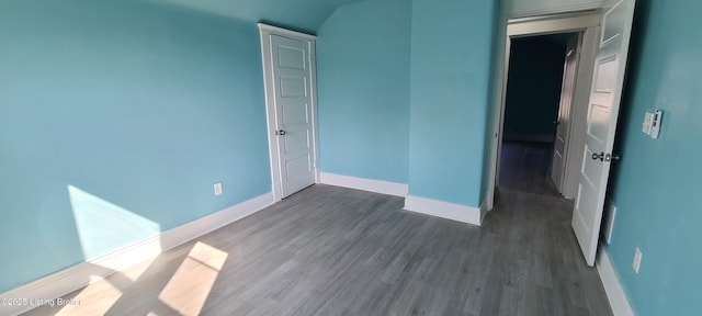 1033 Lynnhurst Ave, Louisville, KY 40215 - unfurnished bedroom with baseboards, dark wood-type flooring, and lofted ceiling