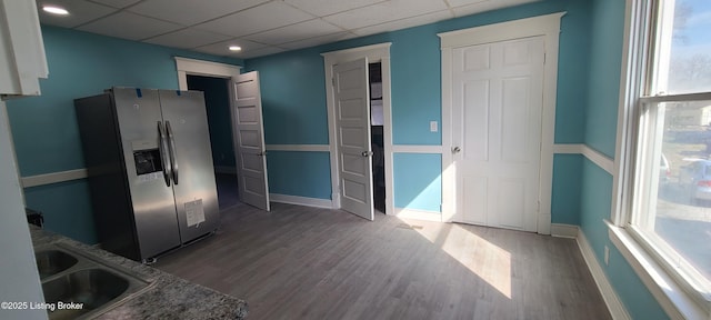 1033 Lynnhurst Ave, Louisville, KY 40215 - kitchen featuring stainless steel refrigerator with ice dispenser, a sink, wood finished floors, baseboards, and a paneled ceiling