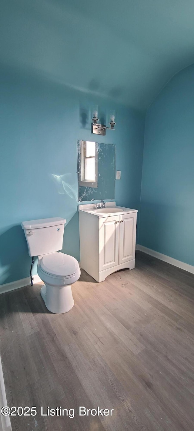 1033 Lynnhurst Ave, Louisville, KY 40215 - bathroom with wood finished floors, toilet, vanity, and baseboards