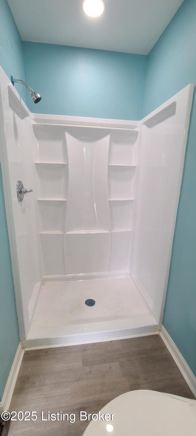 1033 Lynnhurst Ave, Louisville, KY 40215 - bathroom with a stall shower, wood finished floors, and baseboards