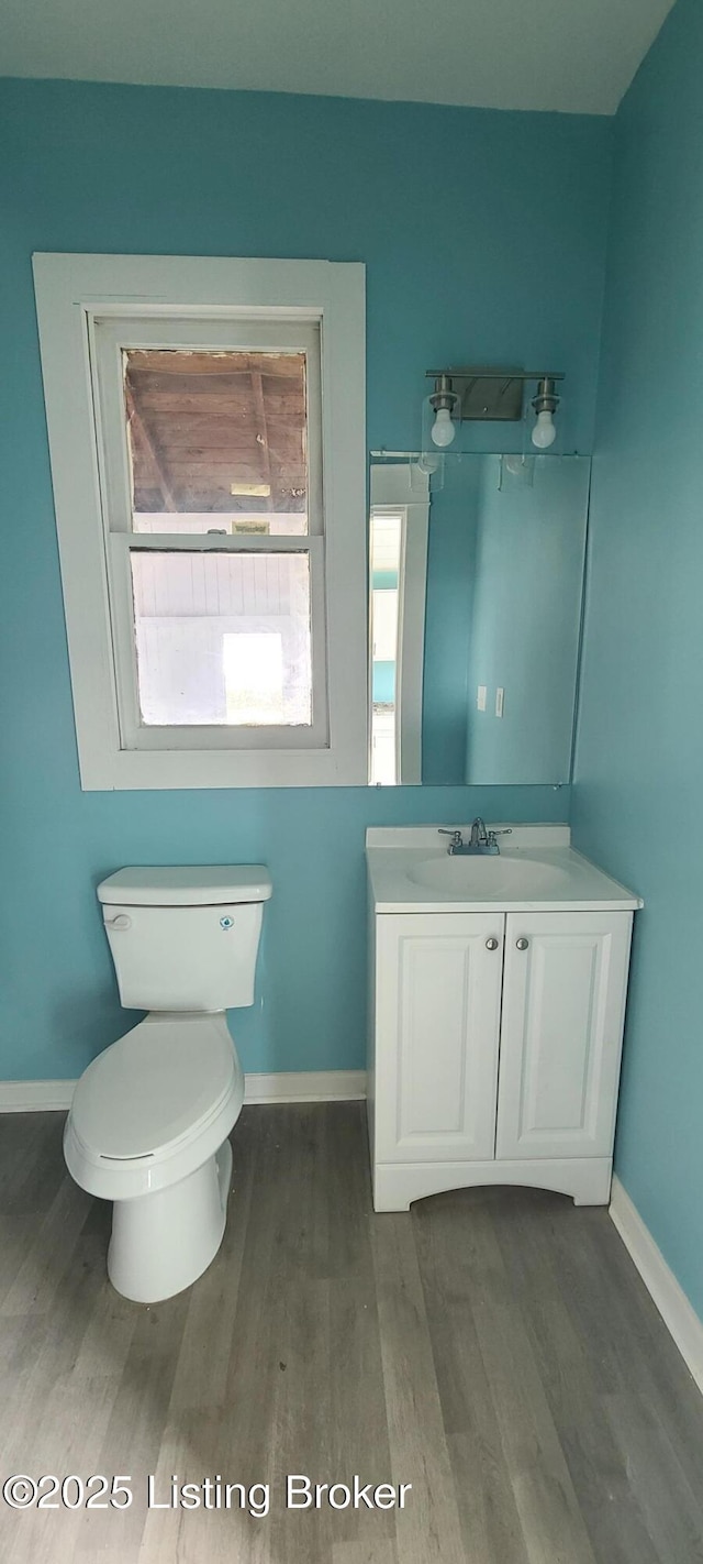1033 Lynnhurst Ave, Louisville, KY 40215 - half bath with wood finished floors, baseboards, toilet, and vanity