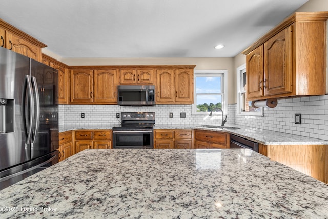 916 Winchester Blvd, Elizabethtown, KY 42701 - kitchen with appliances with stainless steel finishes, a sink, light stone countertops, and brown cabinets