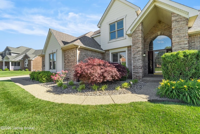 916 Winchester Blvd, Elizabethtown, KY 42701 - view of home's exterior with brick siding, a lawn, and a shingled roof