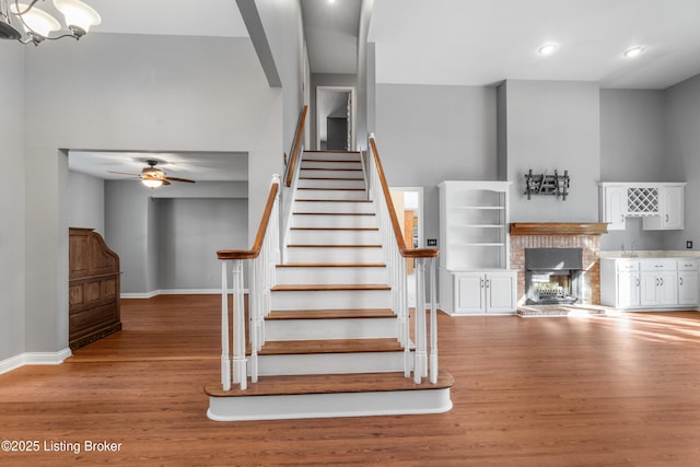 916 Winchester Blvd, Elizabethtown, KY 42701 - staircase with wood finished floors, baseboards, a fireplace, ceiling fan, and recessed lighting