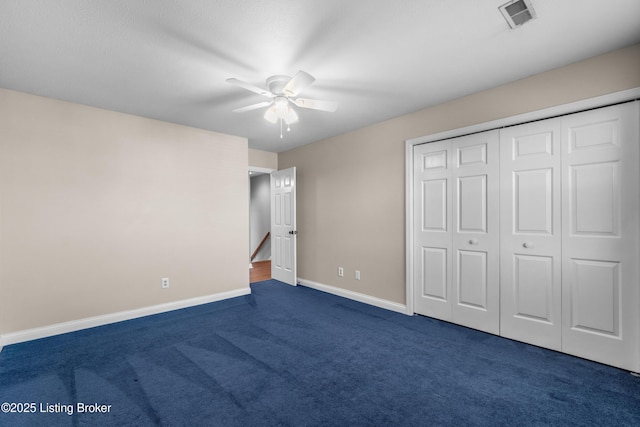 916 Winchester Blvd, Elizabethtown, KY 42701 - unfurnished bedroom featuring dark carpet, baseboards, a ceiling fan, and a closet