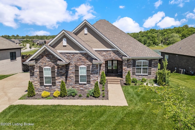 15905 Cabin View Ln, Louisville, KY 40245 - view of front facade featuring stone siding, a front lawn, central AC unit, and french doors