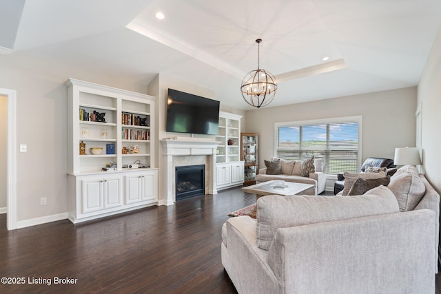 15905 Cabin View Ln, Louisville, KY 40245 - living area featuring a tray ceiling, dark wood finished floors, a chandelier, a glass covered fireplace, and recessed lighting