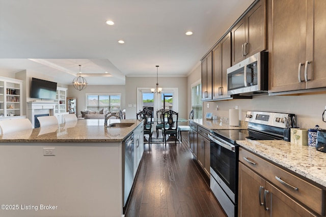 15905 Cabin View Ln, Louisville, KY 40245 - kitchen featuring stainless steel appliances, a sink, light stone countertops, a chandelier, and an island with sink