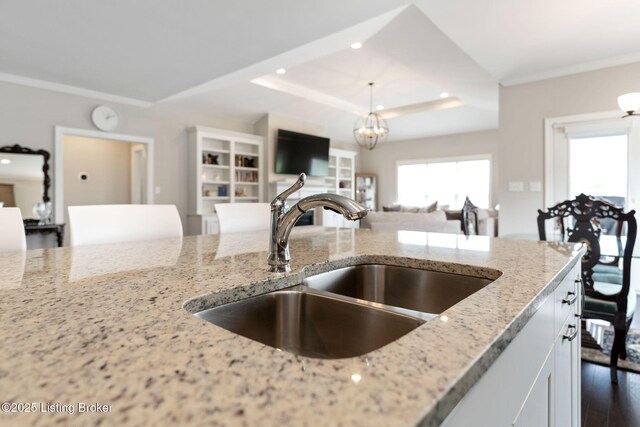 15905 Cabin View Ln, Louisville, KY 40245 - kitchen featuring a sink, light stone counters, a raised ceiling, open floor plan, and white cabinetry