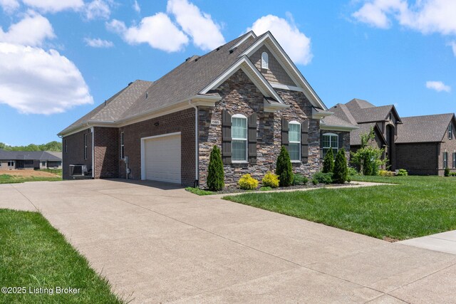 15905 Cabin View Ln, Louisville, KY 40245 - craftsman inspired home featuring driveway, an attached garage, stone siding, a front lawn, and central AC unit