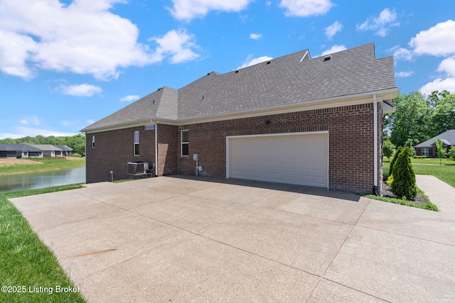15905 Cabin View Ln, Louisville, KY 40245 - rear view of house featuring roof with shingles, brick siding, a water view, and central air condition unit
