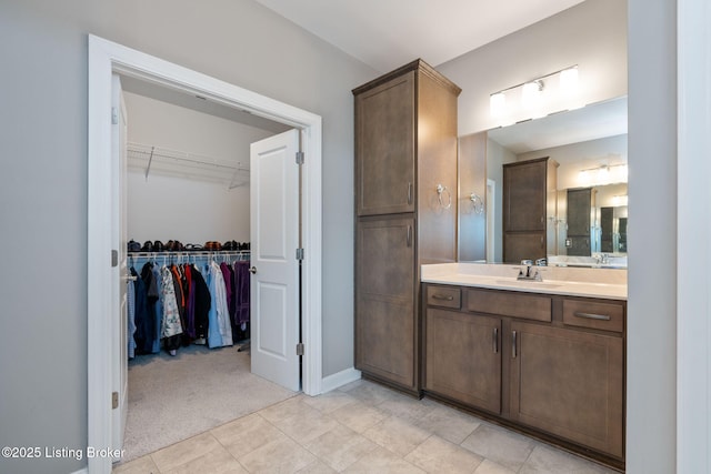 15905 Cabin View Ln, Louisville, KY 40245 - bathroom featuring vanity, a walk in closet, tile patterned flooring, and baseboards