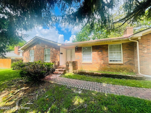 4302 Woodgate Ln, Louisville, KY 40220 - ranch-style house featuring brick siding, a chimney, and fence