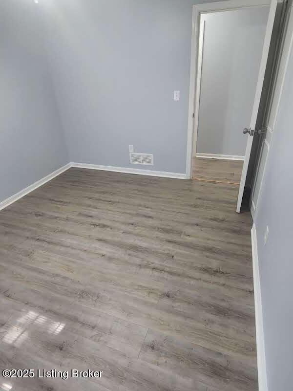 4302 Woodgate Ln, Louisville, KY 40220 - spare room featuring wood finished floors and baseboards