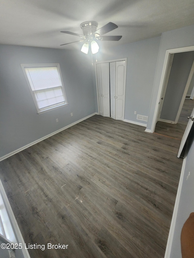 4302 Woodgate Ln, Louisville, KY 40220 - unfurnished bedroom with dark wood-style flooring, baseboards, and a closet