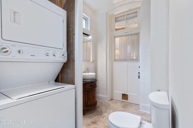 1204 S 2nd St Unit 1, Louisville, KY 40203 - clothes washing area with estacked washer and dryer and a sink