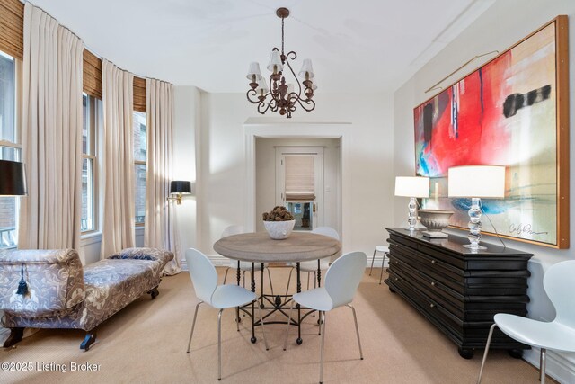 1204 S 2nd St Unit 1, Louisville, KY 40203 - carpeted dining space featuring a chandelier and baseboards