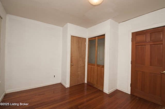 357 Ridgeway Ave, Louisville, KY 40207 - unfurnished bedroom featuring dark wood-type flooring and baseboards