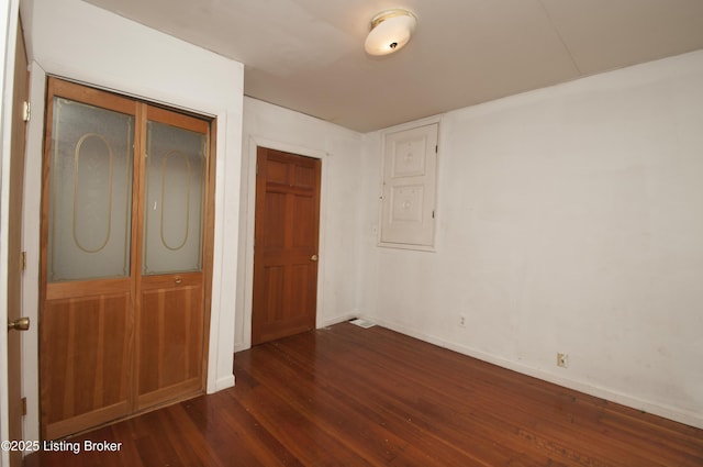 357 Ridgeway Ave, Louisville, KY 40207 - unfurnished bedroom with dark wood-type flooring, baseboards, and a closet