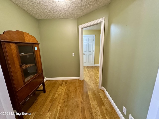 11569 New Haven Rd, New Haven, KY 40051 - hallway with wood finished floors, a textured ceiling, and baseboards