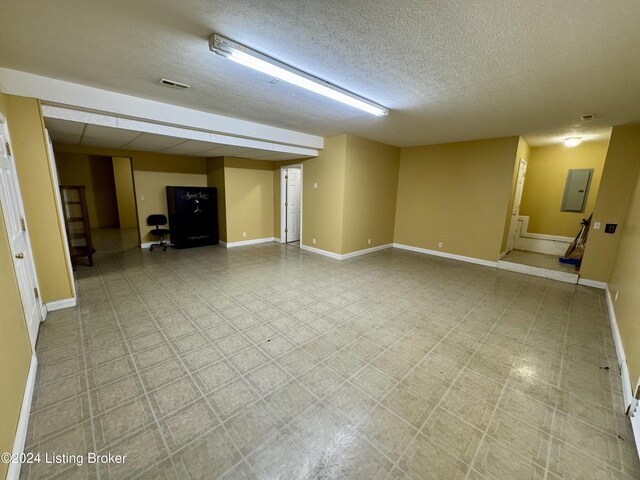 11569 New Haven Rd, New Haven, KY 40051 - unfurnished living room with a textured ceiling, baseboards, and electric panel