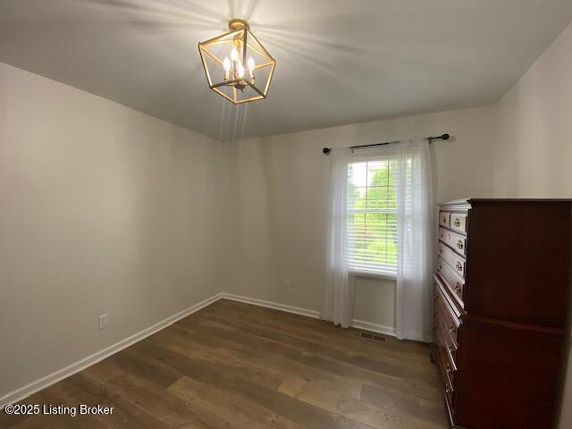 6780 Murrays Run Rd, Coxs Creek, KY 40013 - empty room with a chandelier, baseboards, and wood finished floors
