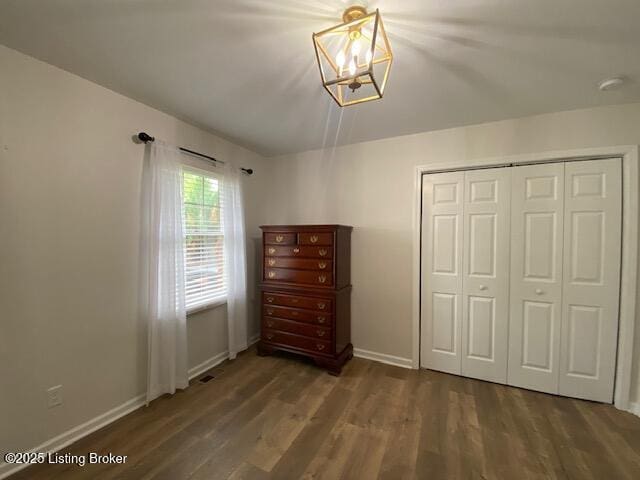 6780 Murrays Run Rd, Coxs Creek, KY 40013 - unfurnished bedroom with wood finished floors, baseboards, a chandelier, and a closet