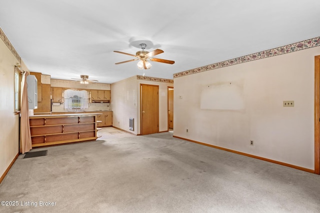 2200 Anneta Rd, Leitchfield, KY 42754 - unfurnished living room with baseboards, ceiling fan, and light colored carpet