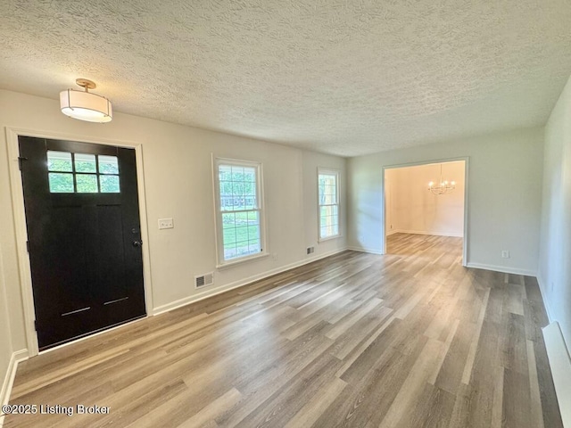 4813 Fox Chase Dr, Shepherdsville, KY 40165 - entrance foyer with a chandelier, wood finished floors, a textured ceiling, and baseboards