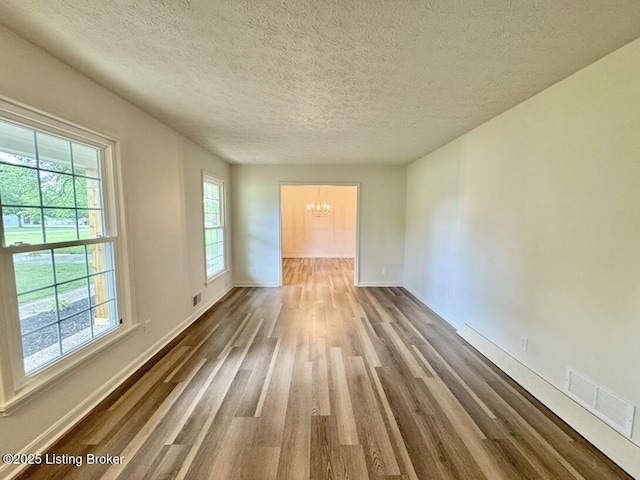 4813 Fox Chase Dr, Shepherdsville, KY 40165 - empty room featuring a chandelier, wood finished floors, a textured ceiling, and baseboards