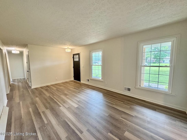 4813 Fox Chase Dr, Shepherdsville, KY 40165 - unfurnished living room featuring a textured ceiling, wood finished floors, and baseboards