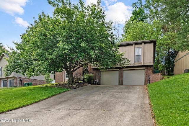 4211 Machupe Dr, Louisville, KY 40241 - view of front of property featuring concrete driveway, a garage, brick siding, and a front lawn