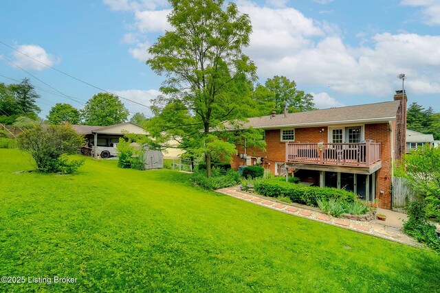 view of grassy yard featuring a wooden deck