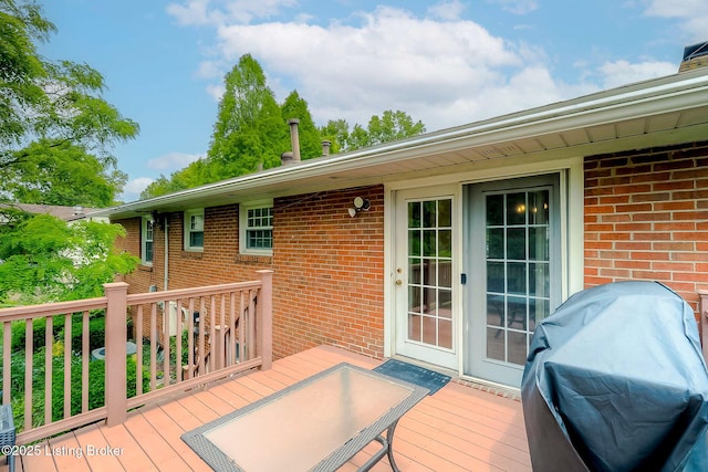 wooden deck with a grill