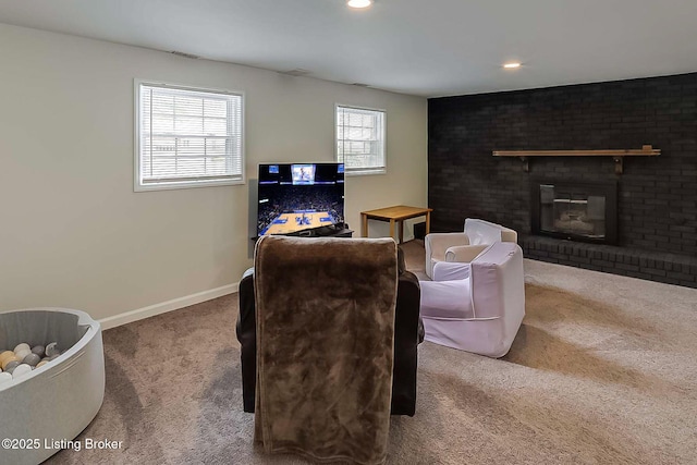 carpeted living area featuring a brick fireplace, baseboards, and recessed lighting