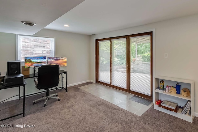 office area featuring healthy amount of natural light, carpet, baseboards, and tile patterned flooring