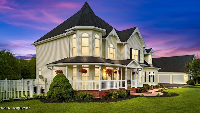 victorian home featuring covered porch and a shingled roof