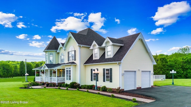 view of front of home featuring a porch, a front yard, asphalt driveway, and roof with shingles