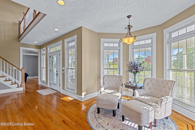 entrance foyer featuring baseboards, wood finished floors, stairs, and recessed lighting