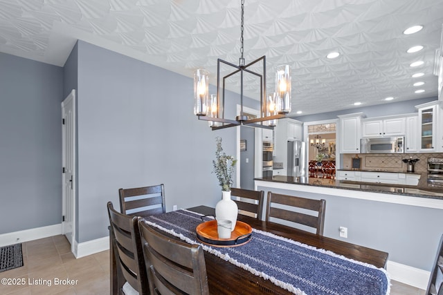 dining area featuring a chandelier, recessed lighting, baseboards, and light tile patterned floors