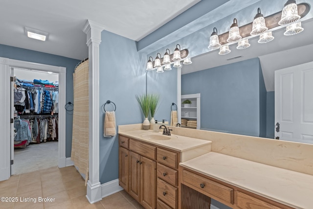 full bathroom with vanity, tile patterned floors, a spacious closet, baseboards, and a shower with curtain