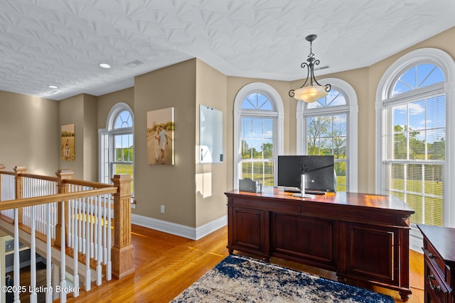 office space featuring baseboards and light wood-type flooring
