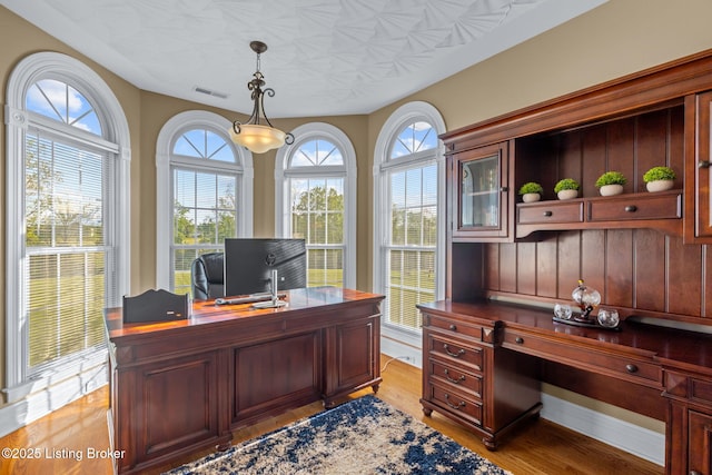 office with light wood-type flooring