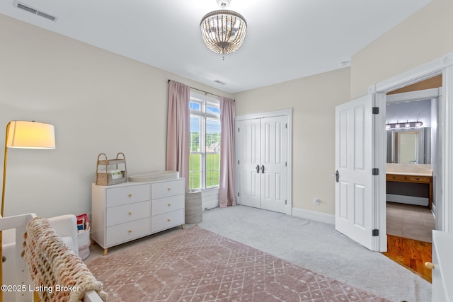 bedroom featuring carpet flooring, a chandelier, baseboards, and a closet
