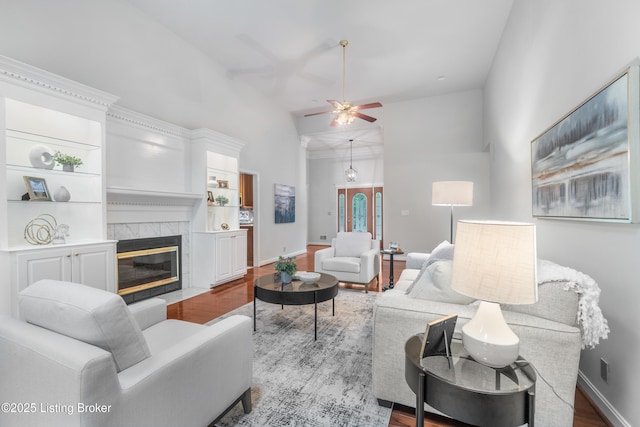 10304 Spring Meyer Rd, Louisville, KY 40223 - living area featuring a ceiling fan, wood finished floors, high vaulted ceiling, a high end fireplace, and baseboards