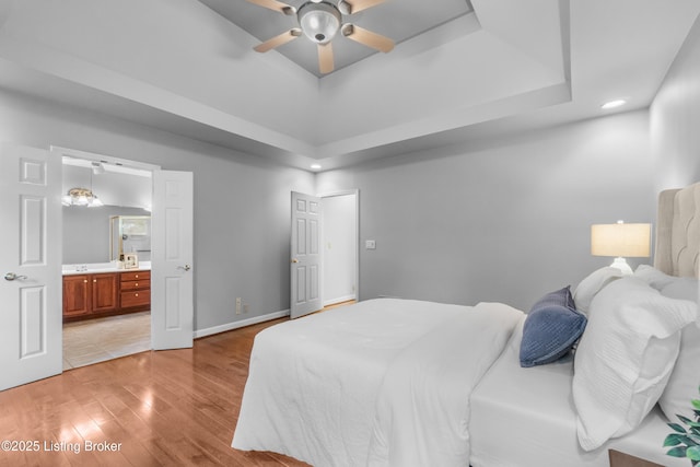 10304 Spring Meyer Rd, Louisville, KY 40223 - bedroom with light wood-style floors, a raised ceiling, connected bathroom, baseboards, and ceiling fan